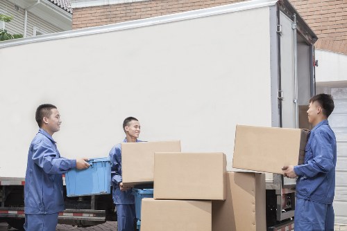 Professional mover loading furniture into a van in Fulham