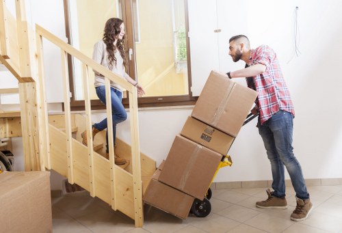 Packed moving boxes and furniture in a Fulham apartment