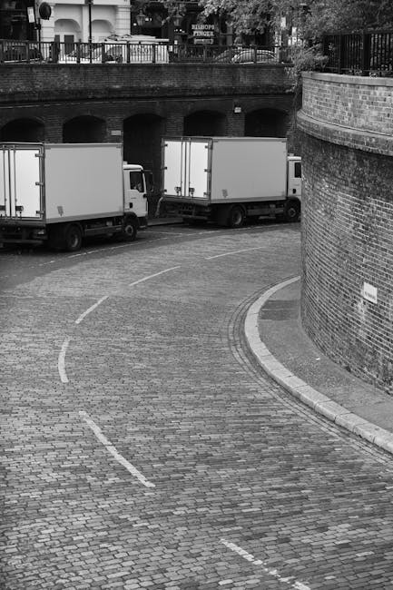 A residential street in Fulham lined with parked cars on both sides, including vehicles such as hatchbacks, sedans, and vans, some of which are covered with protective fabric or plastic wrap. The road